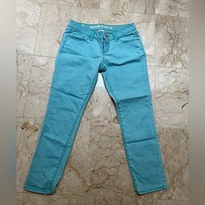 Mission Supply Co teal colored jeans.